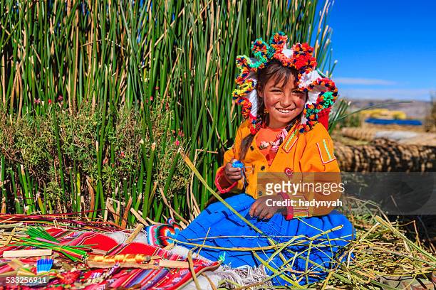 kleines mädchen auf uros floating island denen souvenirs, lake tititcaca - quechua stock-fotos und bilder