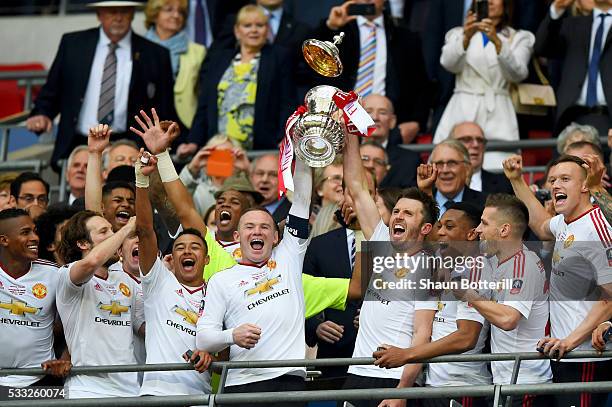 Wayne Rooney and Michael Carrick of Manchester United lift the trophy after winning The Emirates FA Cup Final match between Manchester United and...