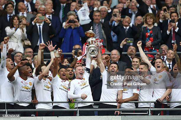 Wayne Rooney and Michael Carrick of Manchester United lift the trophy after winning The Emirates FA Cup Final match between Manchester United and...