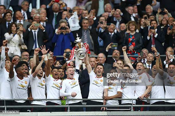 Wayne Rooney and Michael Carrick of Manchester United lift the trophy after winning The Emirates FA Cup Final match between Manchester United and...