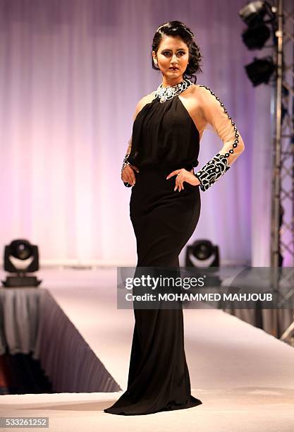 Model presents a creation by Omani fashion designer Salha al-Farsi during the Omani Women's Fashion Trends event on May 21 in the capital Muscat. /...
