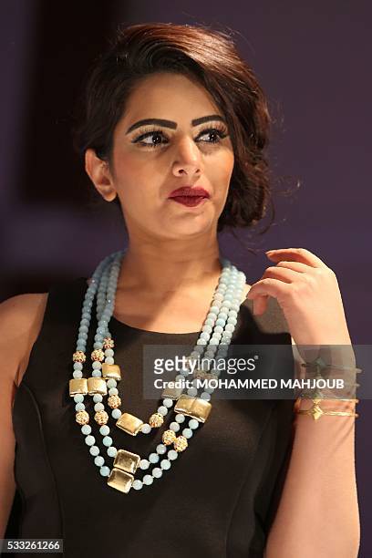 Model presents a creation by Vivat jewellery during the Omani Women's Fashion Trends event on May 21 in the capital Muscat. / AFP / MOHAMMED MAHJOUB