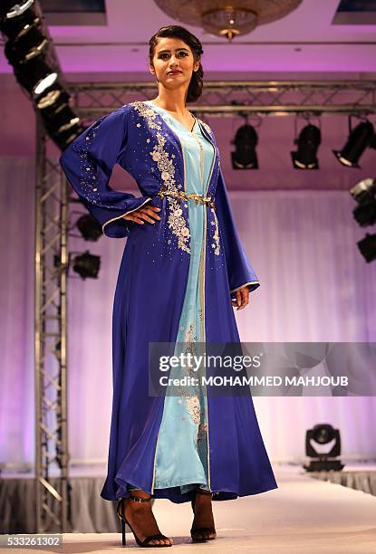 Model presents a creation by Omani fashion designer Hala al-Maamari during the Omani Women's Fashion Trends event on May 21 in the capital Muscat. /...