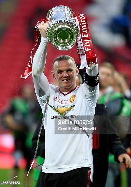 Wayne Rooney of Manchester United celebrates with the trophy after winning The Emirates FA Cup Final match between Manchester United and Crystal...