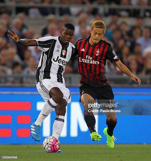 Paul Pogba of Juventus FC competes for the ball with Keisuke Honda of AC Milan during the TIM Cup final match between AC Milan and Juventus FC at...