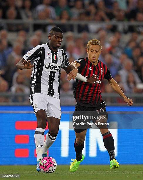 Paul Pogba of Juventus FC competes for the ball with Keisuke Honda of AC Milan during the TIM Cup final match between AC Milan and Juventus FC at...