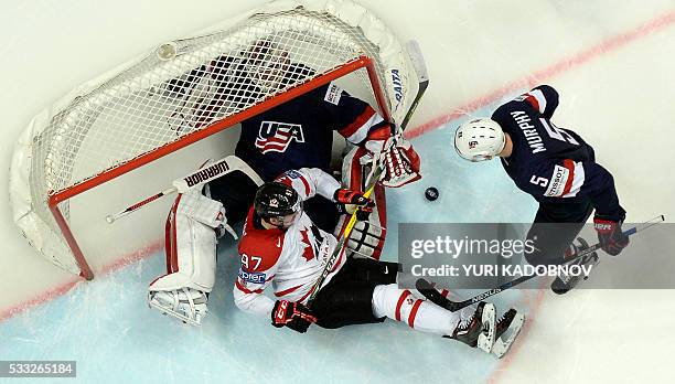 Canada's forward Connor McDavid vies with US defender Connor Murphy as US goalie Keith Kinkaid makes a save during the semifinal game Canada vs USA...