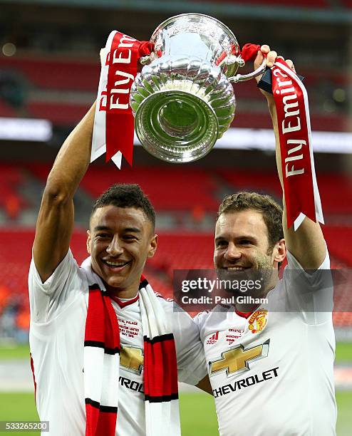 Goalscorers Jesse Lingard and Juan Mata of Manchester United celebrate with the trophy after winning The Emirates FA Cup Final match between...