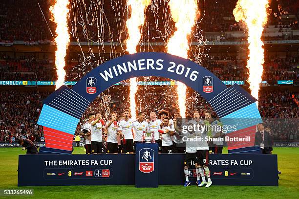 Manchester United players celebrate victory with the trophy after The Emirates FA Cup Final match between Manchester United and Crystal Palace at...