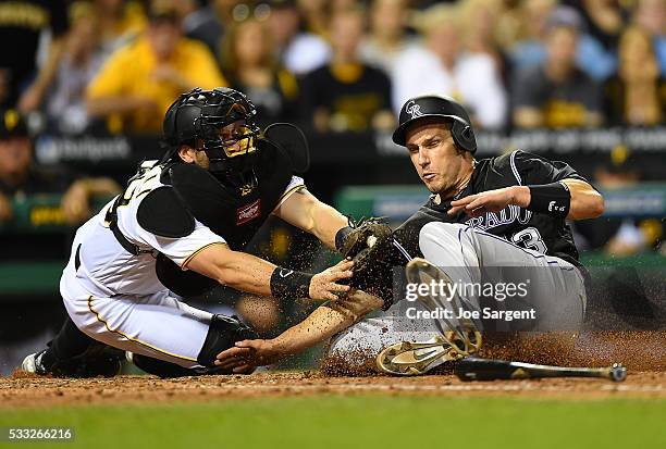 Dustin Garneau of the Colorado Rockies is tagged out at home plate by Francisco Cervelli of the Pittsburgh Pirates during the seventh inning on May...