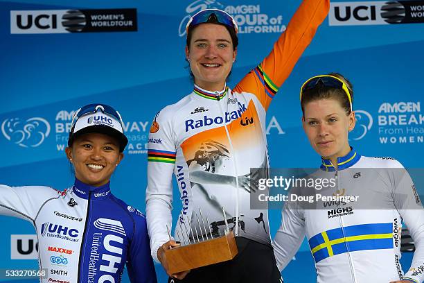 Marianne Vos of The Netherlands riding for Rabo-Liv Women Cycling Team takes the podium after winning stage three along with Coryn Rivera of the...