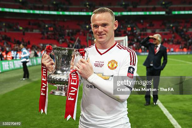 Wayne Rooney of Manchester United poses for photographs with the trophy after The Emirates FA Cup Final match between Manchester United and Crystal...