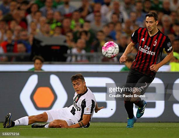 Paulo Dybala of Juventus FC competes for the ball with Mattia De Sciglio of AC Milan during the TIM Cup final match between AC Milan and Juventus FC...
