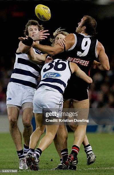 Fraser Gehrig for the Saints is tackled by Henry Playfair, Gary Ablett and Paul Koulouriotis for the Cats during the round nineteen AFL match between...