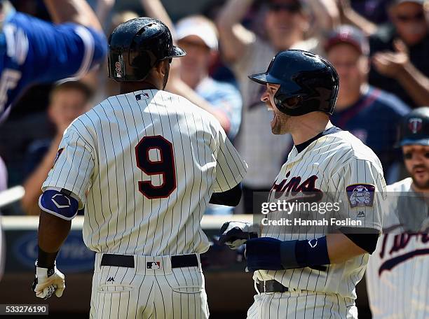 Brian Dozier of the Minnesota Twins congratulates teammate Eduardo Nunez on a three-run home run against the Toronto Blue Jays during the eighth...