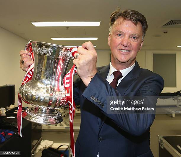 Manager Louis van Gaal of Manchester United celebrates in the dressing room with the FA Cup trophy after The Emirates FA Cup final match between...