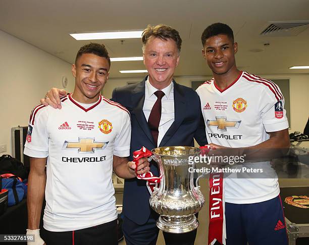 Jesse Lingard, Manager Louis van Gaal and Marcus Rashford of Manchester United celebrate in the dressing room with the FA Cup trophy after The...