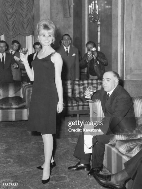 French actress Brigitte Bardot at a press conference in Rome to promote her new film 'Le Mepris', producer Carlo Ponti is on the right, 22nd April...
