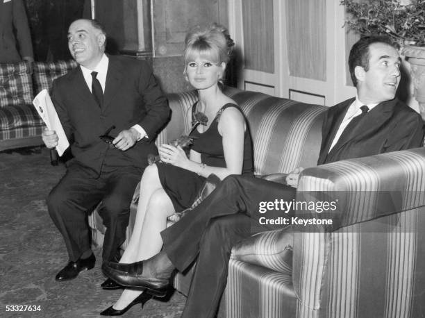 French actress Brigitte Bardot at a press conference in Rome to promote her new film 'Le Mepris'. Producer Carlo Ponti sits on her left and director...