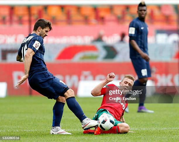Dmitri Barinov of FC Lokomotiv Moscow challenged by Dalibor Stevanovic of FC Mordovia Saransk during the Russian Premier League match between FC...
