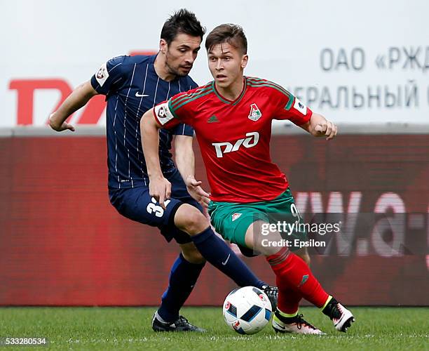 Rifat Zhemaletdinov of FC Lokomotiv Moscow challenged by Marko Lomic of FC Mordovia Saransk during the Russian Premier League match between FC...