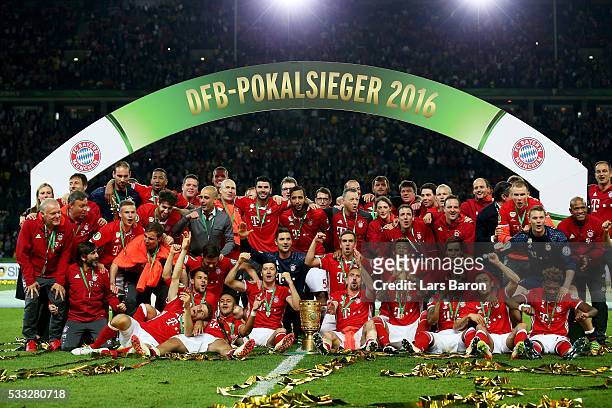 Bayern Muenchen players and team pose for a photo after winning the DFB Cup final match in a penalty shootout against Borussia Dortmund at...