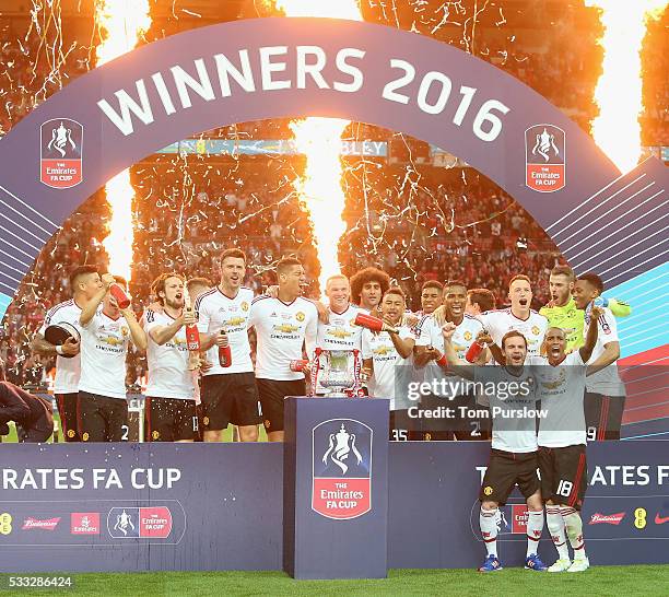 The Manchester United squad celebrate with the FA Cup trophy after The Emirates FA Cup final match between Manchester United and Crystal Palace at...