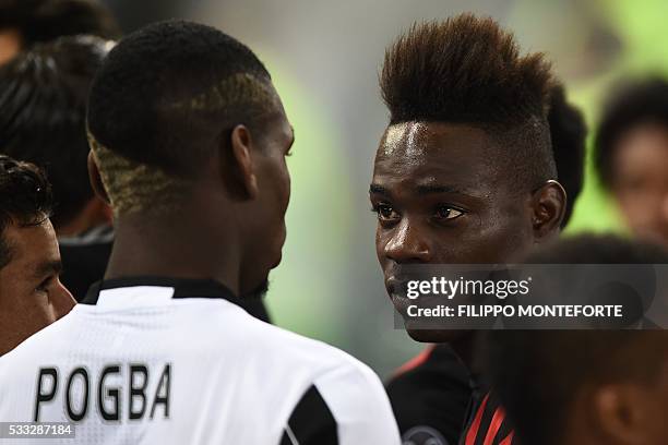 Juventus' midfielder from France Paul Pogba is congratulated by AC Milan's forward from Italy Mario Balotelli at the end of the Italian Tim Cup final...