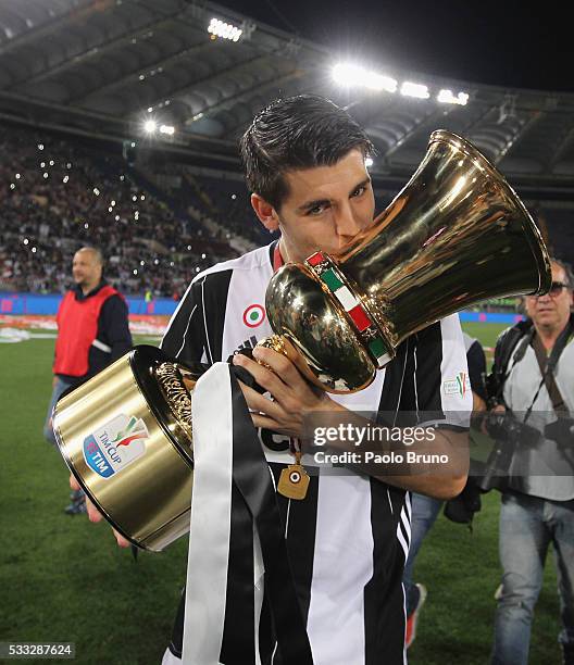 Alvaro Morata of Juventus FC celebrates with the trophy after winning the TIM Cup final match against AC Milan at Stadio Olimpico on May 21, 2016 in...