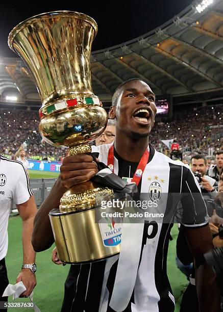 Paul Pogba of Juventus FC celebrates with the trophy after winning the TIM Cup final match against AC Milan at Stadio Olimpico on May 21, 2016 in...