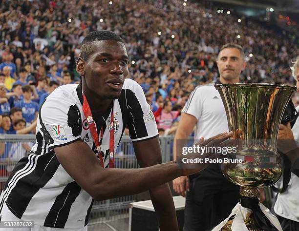 Paul Pogba of Juventus FC celebrates with the trophy after winning the TIM Cup final match against AC Milan at Stadio Olimpico on May 21, 2016 in...
