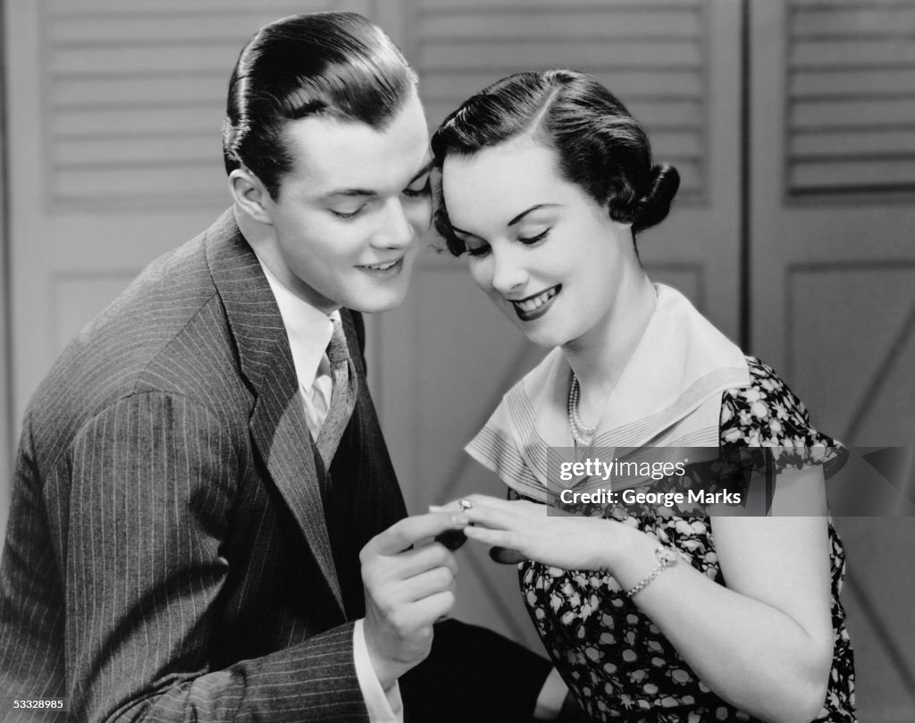 Man looking at woman's ring