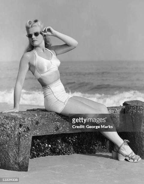 woman sitting near shore - beach glamour stock pictures, royalty-free photos & images
