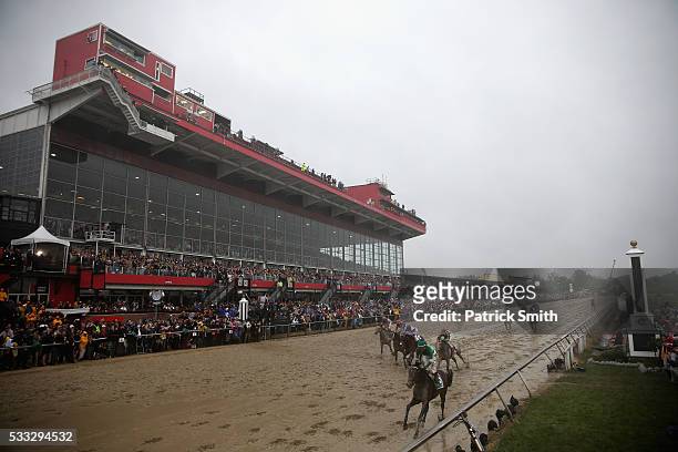 Exaggerator ridden by Kent Desormeaux leads the field to win the 141st running of the Preakness Stakes at Pimlico Race Course on May 21, 2016 in...