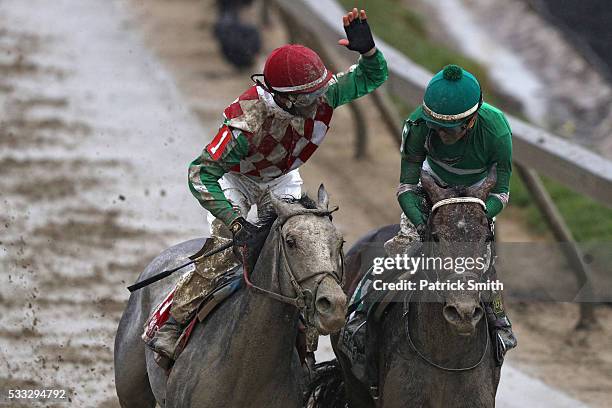 Jockey Corey Lanerie of Cherry Wine celebrates with jockey Kent Desormeaux of Exaggerator after Exaggerator crossed the finish line to win the 141st...