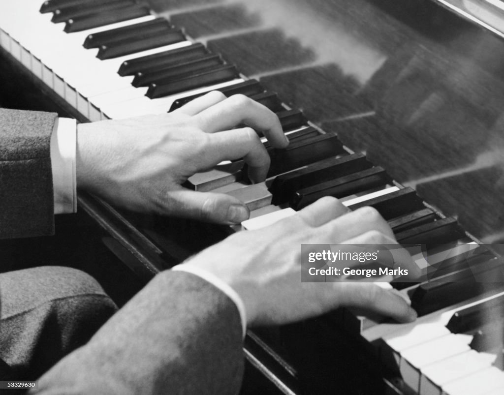 Close-up of hands on piano keys
