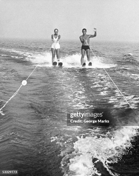 couple water skiing - waterskiing stock pictures, royalty-free photos & images