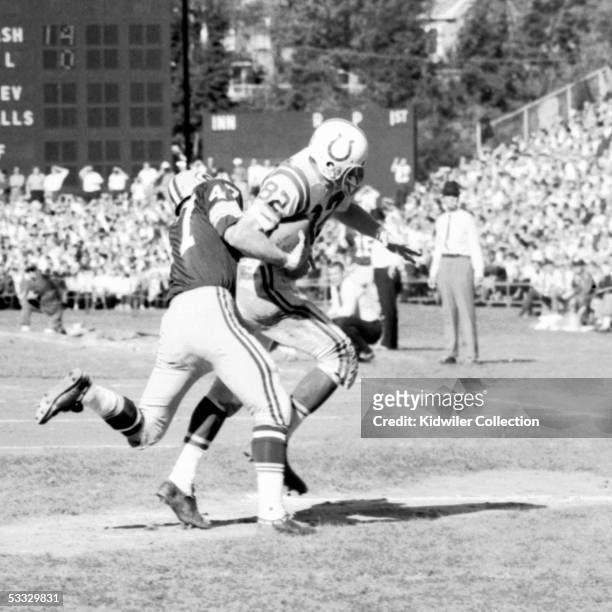 Receiver Raymond Berry of the Baltimore Colts catches a pass in front of Jesse Whittenton of the Green Bay Packers during a game on October 18, 1964...