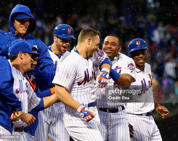 David Wright of the New York Mets is congratulated by Yoenis Cespedes and the rest of his teammates after Wright hit a walk off single to win the...