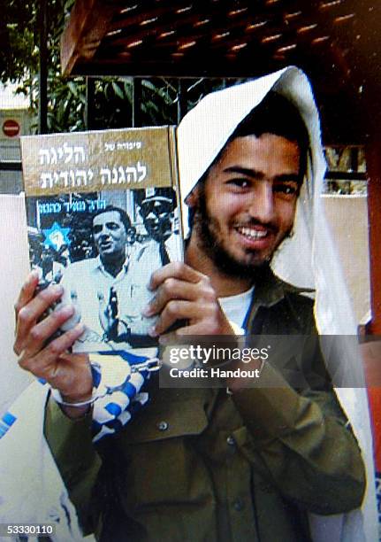 Recent photo made available by an extremist Jewish settler August 5, 2005 shows Israeli gunman Eden Natan-Zada posing for a photo holding a book by...