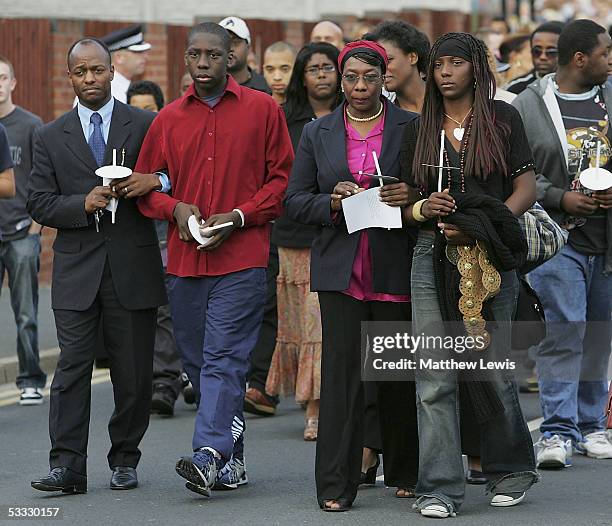 Mother of 18-year-old Anthony Walker, Gee Walker is consoled during a candlelit procession from St.Gabriel's church in Hall Lane to McGoldrick Park,...