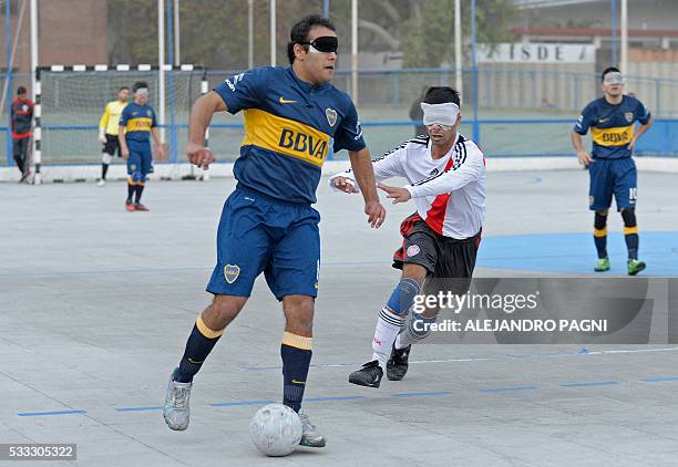 Boca Juniors' Luis Rodriguez vies for the ball past River Plate's Gustavo Maidana during a blind football match of the Argentine FaDeC championship...