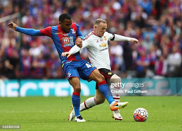 Wayne Rooney of Manchester United and Jason Puncheon of Crystal Palace battle for the ball during The Emirates FA Cup Final match between Manchester...
