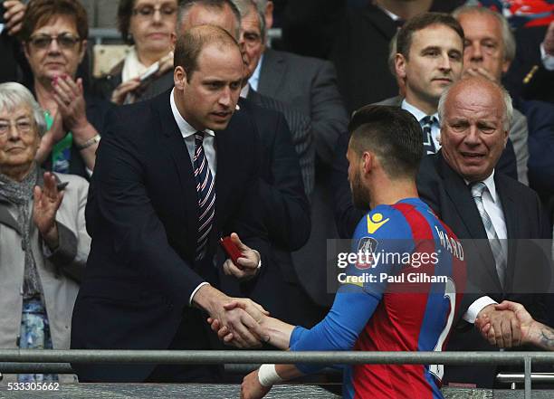 Prince William, Duke of Cambridge shakes hands with Joel Ward of Crystal Palace in defeat after The Emirates FA Cup Final match between Manchester...