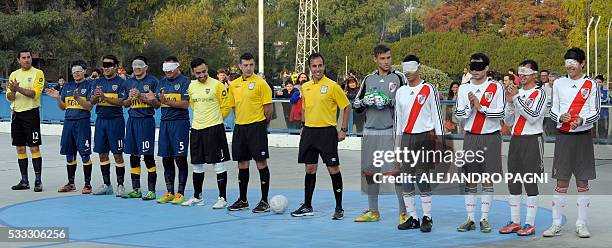 Boca Juniors' and River Plate's footballer prepare to start a blind football match of the Argentine FaDeC championship in Buenos Aires on May 21,...