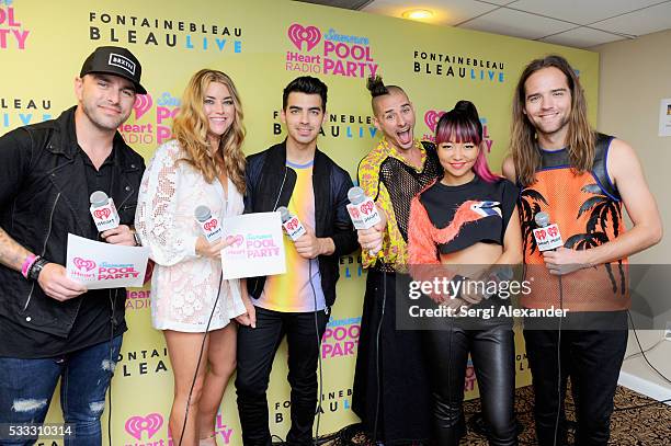 Hosts Billy The Kidd and Anne Hudson pose with Joe Jonas, Cole Whittle, JinJoo Lee and Jack Lawless of DNCE at 2016 iHeartRadio Summer Pool Party at...