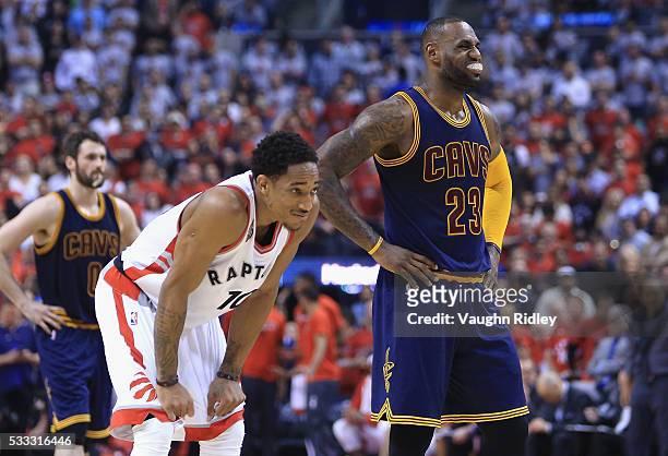 DeMar DeRozan of the Toronto Raptors and LeBron James of the Cleveland Cavaliers look on during the first half in game three of the Eastern...