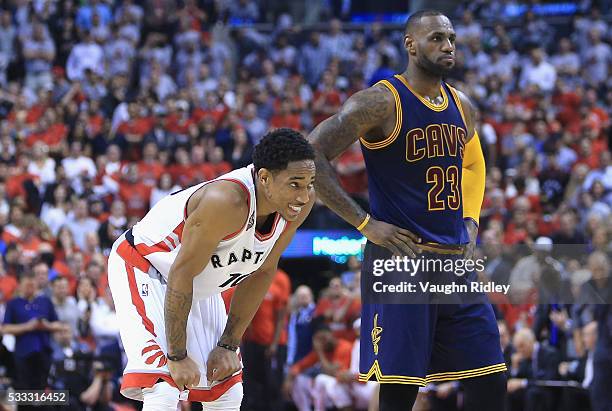 DeMar DeRozan of the Toronto Raptors and LeBron James of the Cleveland Cavaliers look on during the first half in game three of the Eastern...