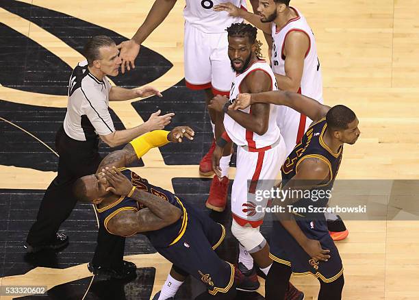 LeBron James of the Cleveland Cavaliers reacts after being hit in the face by teammate Tristan Thompson during the first half against the Toronto...
