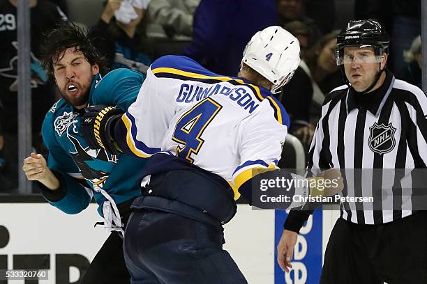 Brenden Dillon of the San Jose Sharks fights with Carl Gunnarsson of the St. Louis Blues in game four of the Western Conference Finals during the...